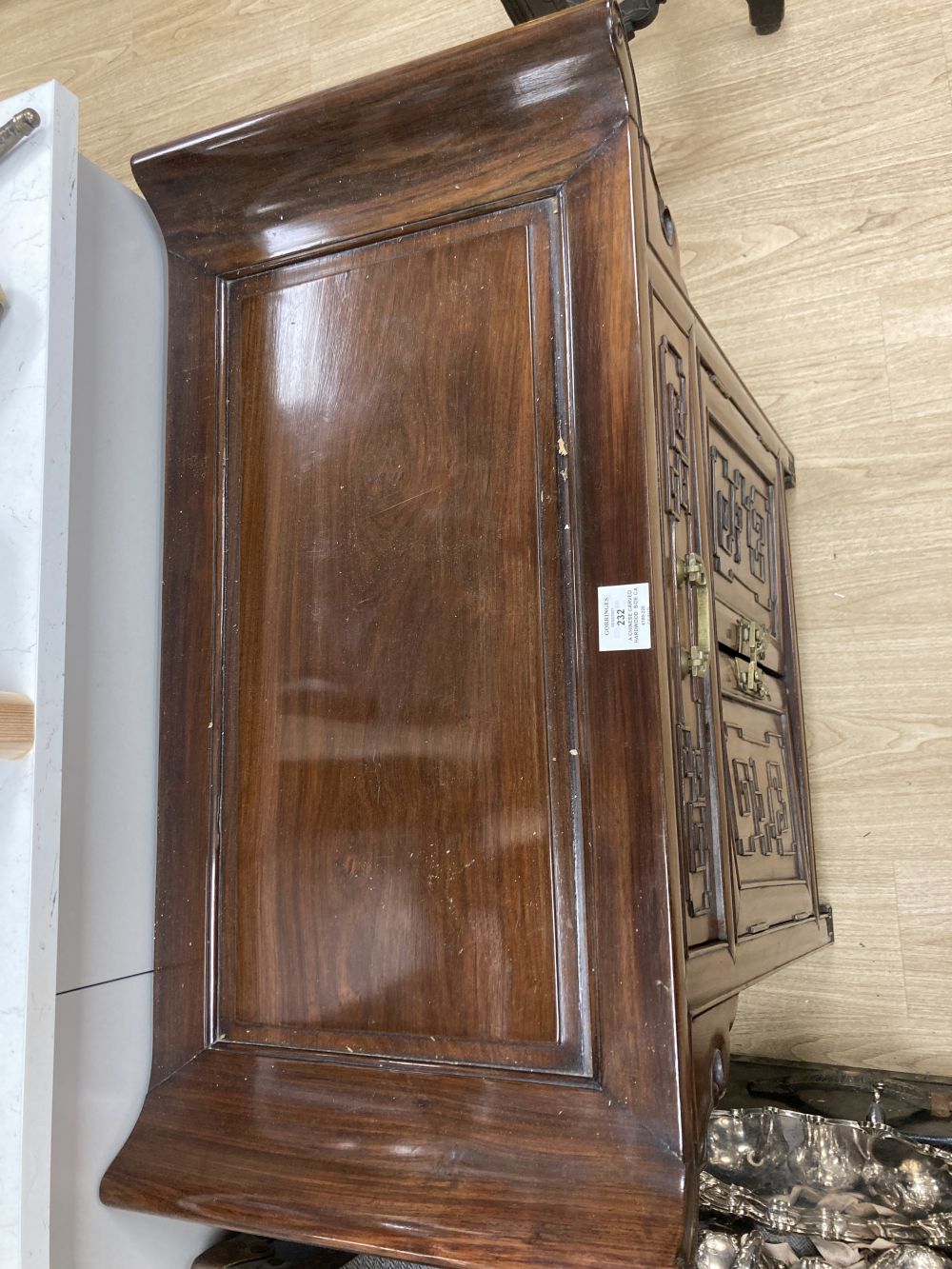 A Chinese carved hardwood side cabinet, fitted one long drawer over a pair of doors, width 70cm depth 38cm height 80cm